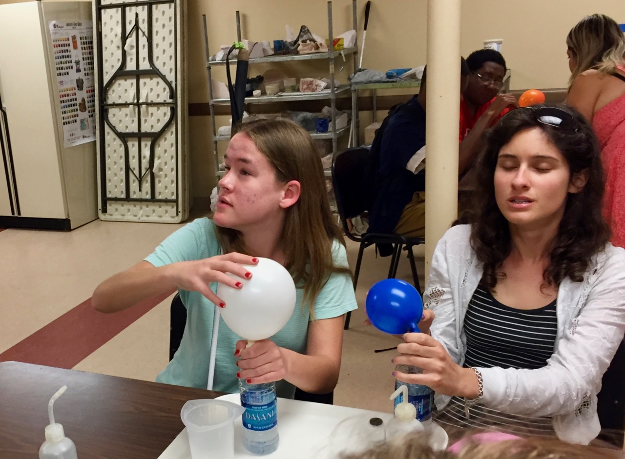Maggie and Lauren experiment with chemically inflating balloons